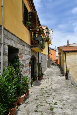 A narrow street between the old houses of Albano di Lucania, a village in the Basilicata region, Italy.