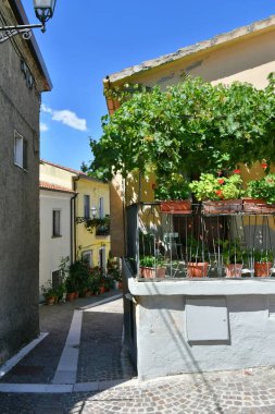 A narrow street among the old houses of Greci, a village in the Campania region, Italy.