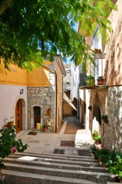 A narrow street among the old houses of Greci, a village in the Campania region, Italy.