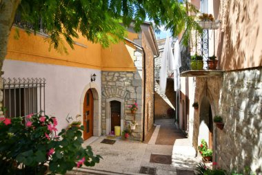 A narrow street among the old houses of Greci, a village in the Campania region, Italy.
