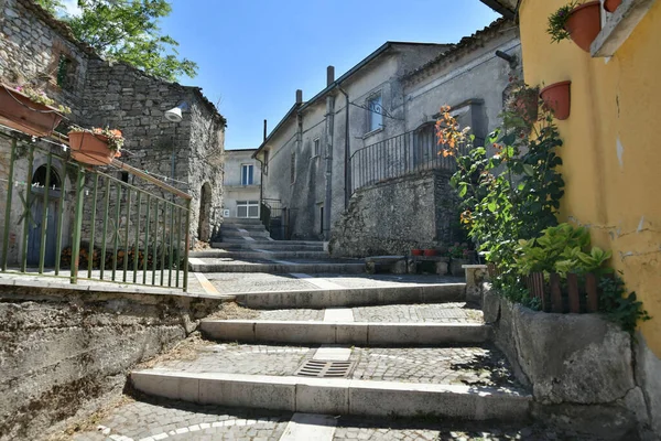 A narrow street among the old houses of Greci, a village in the Campania region, Italy.