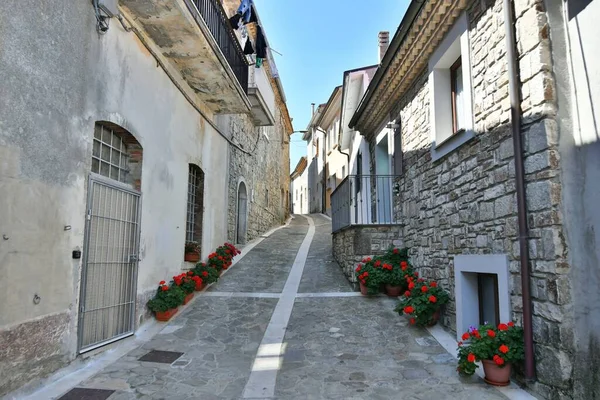 A narrow street among the old houses of Greci, a village in the Campania region, Italy.