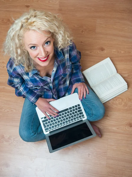Attractive woman with laptop and book — Stock Photo, Image