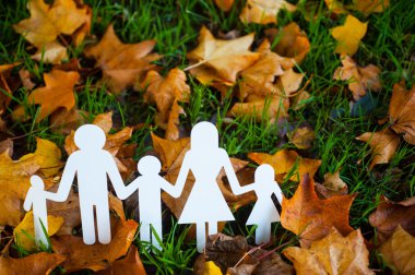 Paper family in autumn grass clipart