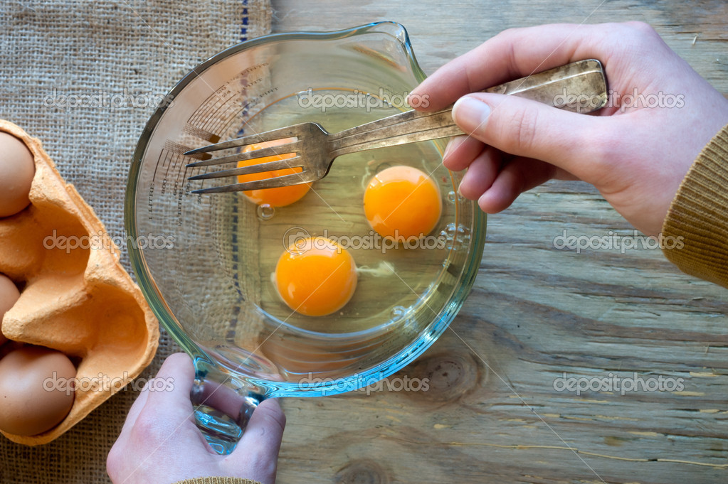 Beating eggs with fork — Stock Photo © gabriel11 42682161