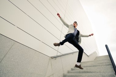 Man, model of fashion, jumping and wearing jacket and shirt