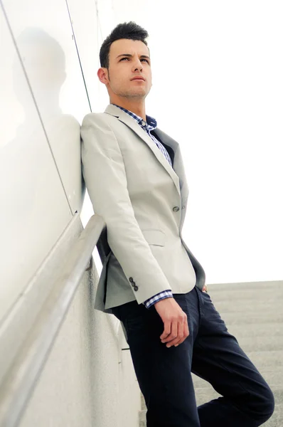 Portrait of a young handsome man, model of fashion, wearing tinted sunglasses — Stock Photo, Image