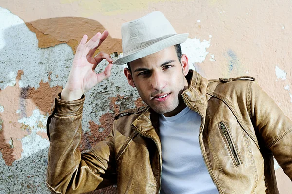 Joven guapo con un sombrero en el fondo urbano —  Fotos de Stock