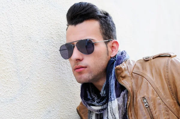 Portrait of a young handsome man, model of fashion, with toupee in urban background — Stock Photo, Image