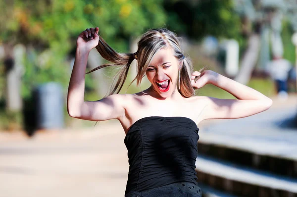 Beautiful and fashion girl with pigtails shouting and dancing — Stock Photo, Image