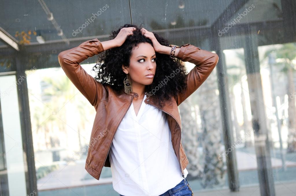Young black woman, model of fashion in urban background