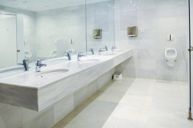 Public empty men restroom with washstands mirror clipart