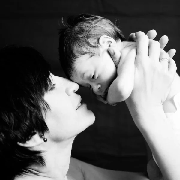 Mother and daughter on black background — Stock Photo, Image