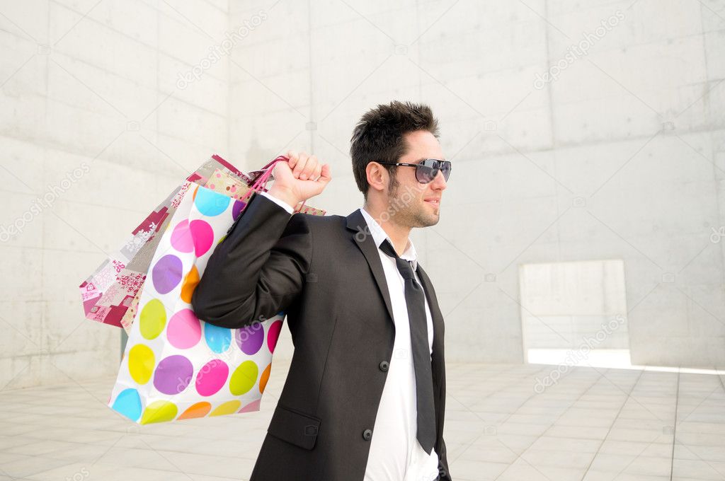 Portrait of a handsome young man with shopping bags