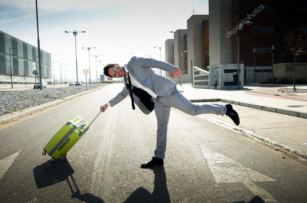 Funny man dressed in suit with a suitcase