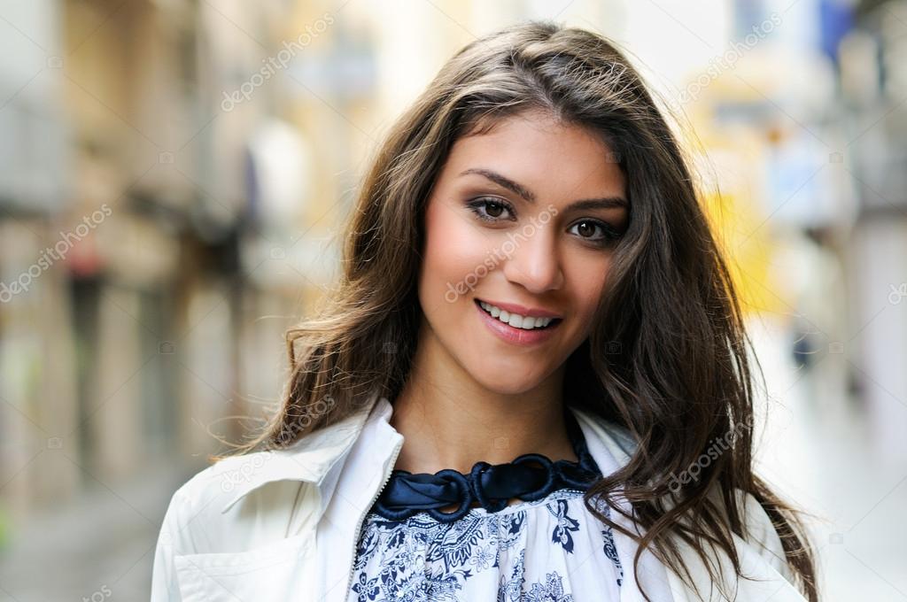 Beautiful woman smiling in urban background