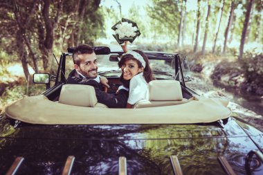 Just married couple in an old car clipart