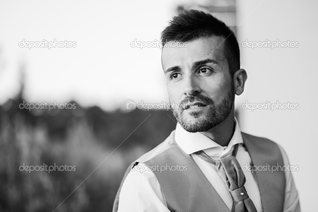 Good looking groom outdoors in a forest