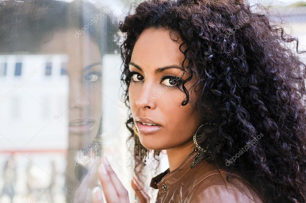 Young black woman, afro hairstyle, in urban background