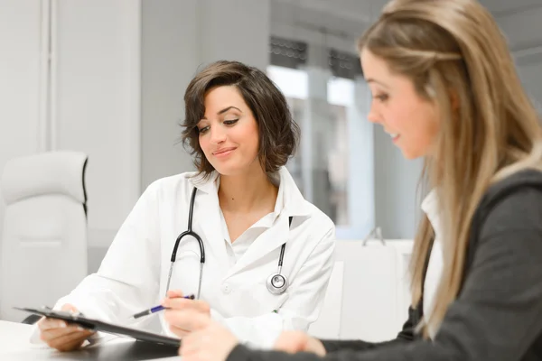 Médico explicando diagnóstico para sua paciente do sexo feminino — Fotografia de Stock