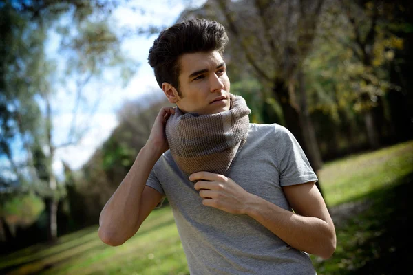 Attractive young handsome man, model of fashion in the park — Stock Photo, Image