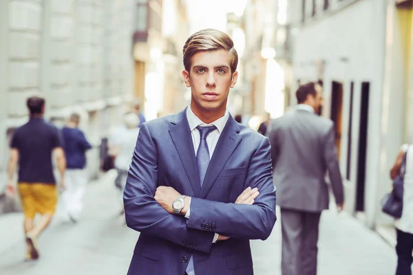 Attractive young businessman in urban background — Stock Photo, Image