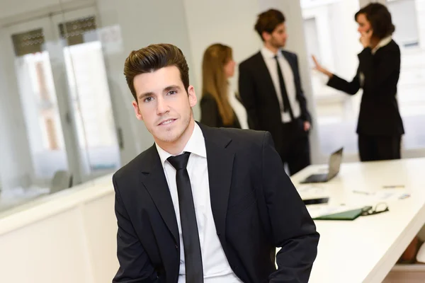 Business leader looking at camera in working environment — Stock Photo, Image