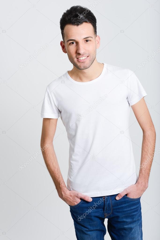 Smiling young man standing against white background 