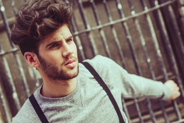 Man wearing suspenders in urban background — Stock Photo, Image