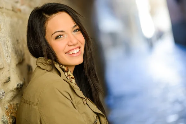 Mujer joven con ojos verdes en el fondo urbano — Foto de Stock