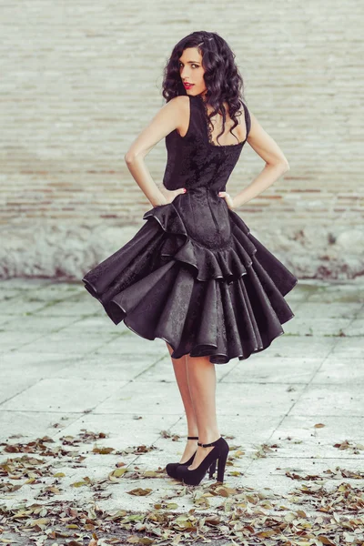 Woman, model of fashion, wearing black dress with curly hair — Stock Photo, Image