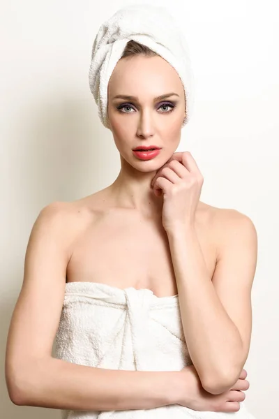 Beautiful blond woman with white towel on her head. — Stock Photo, Image