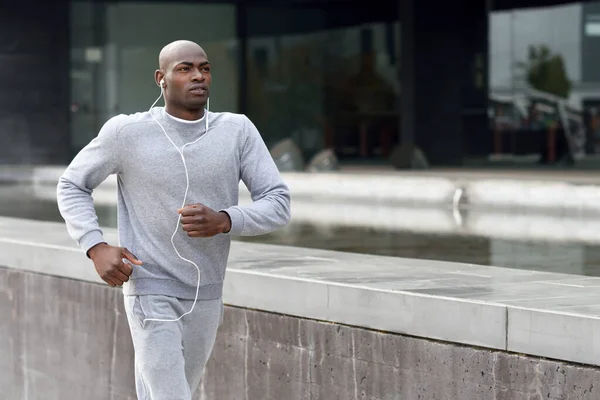 Attractive black man running in urban background