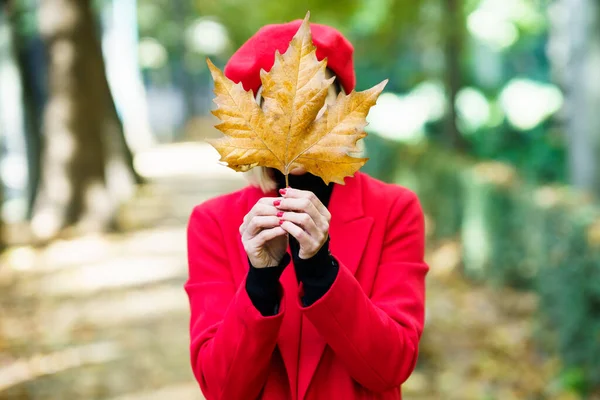 Unrecognizable Female Colorful Coat Covering Face Withered Brown Maple Leaf — Stock Photo, Image