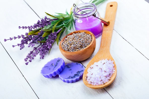 Droge kruiden Lavendel, badzout en kaars, op witte houten tafel — Stockfoto