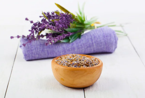 Dry Lavender herbs, and flowers on the serviette, on white woode — Stock Photo, Image