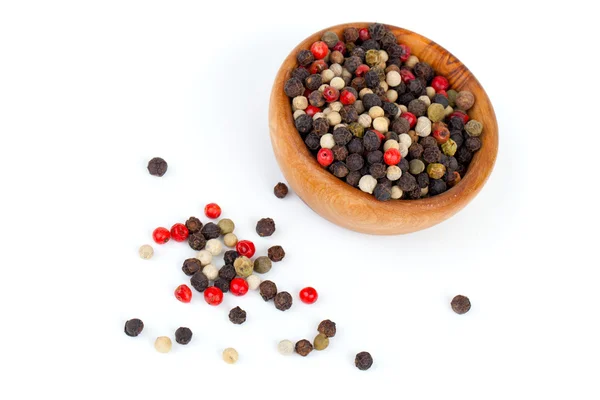 Coloured pepper on a wooden bowl, isolated on white — Stock Photo, Image