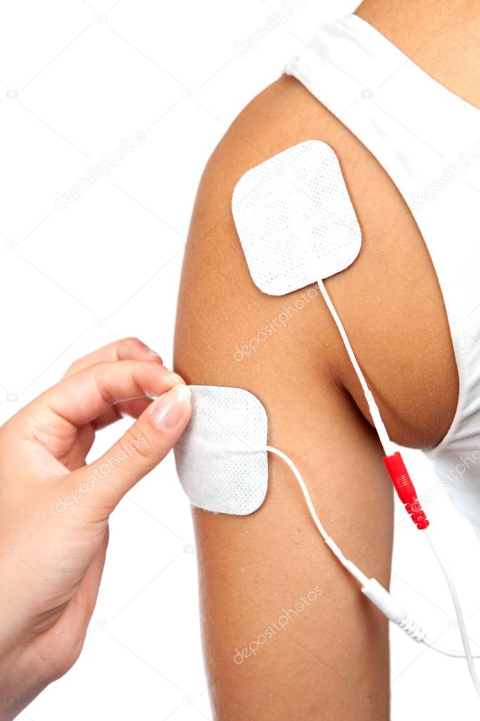 Electrodes of tens device on shoulder, tens therapy, nerve stimu