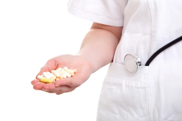 Pills in a hand on white background — Stock Photo, Image