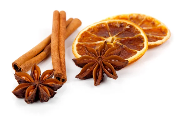 Christmas decoration of whole star anise, orange and cinnamon, on a white background — Stock Photo, Image