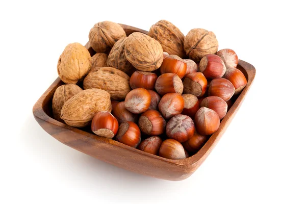Hazelnut and walnut in the wooden bowl. isolated on the white background — Stock Photo, Image