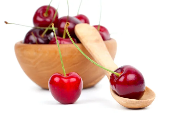 Red cherry in wooden spoon and bowl, isolated on white backgroun — Stock Photo, Image