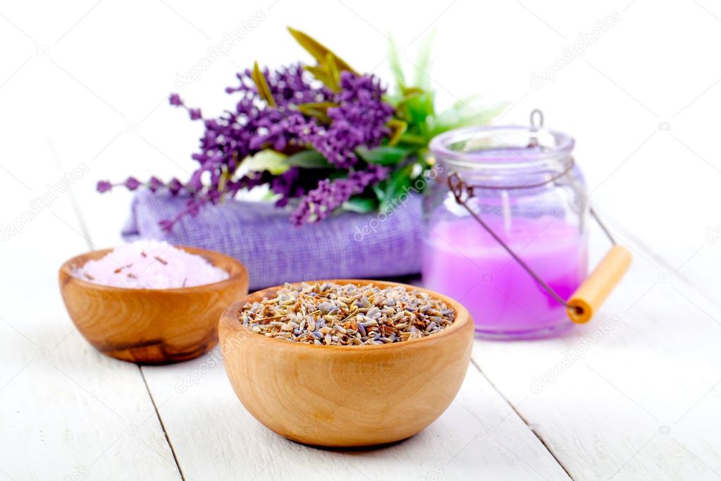 Dry Lavender herbs, bath salt and candle, on white wooden table