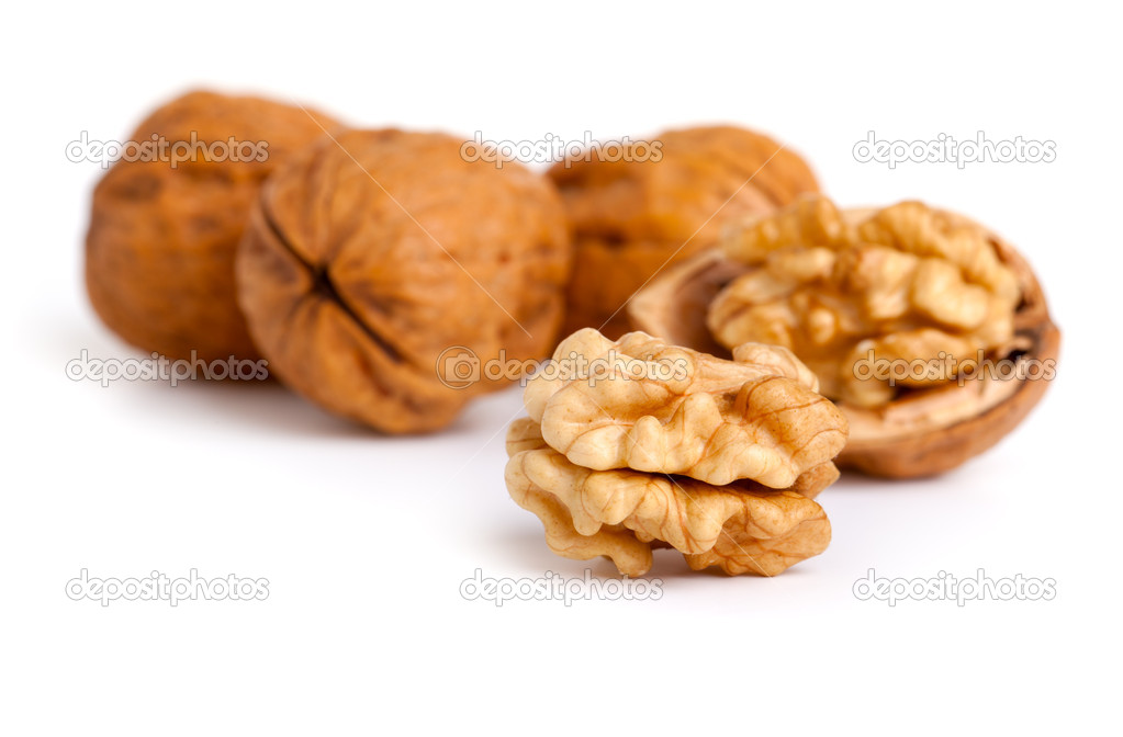 Walnut and a cracked walnut isolated on the white background