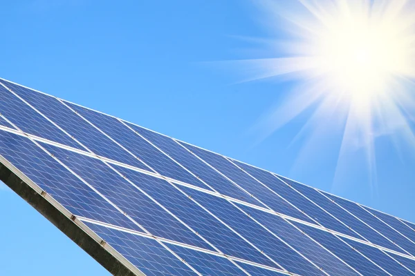 Solar panel against blue sky with sun — Stock Photo, Image