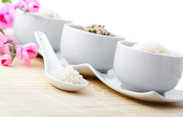 Porcelain bowls of uncooked rice — Stock Photo, Image
