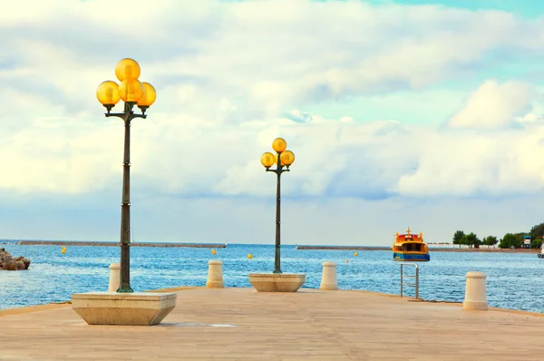 Wooden berth with street-lamp on sea background. Pula Croatia — Stock Photo, Image