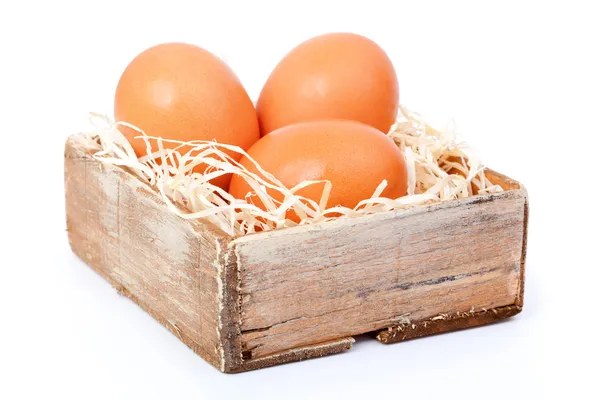 Brown eggs at hay, in the old box — Stock Photo, Image