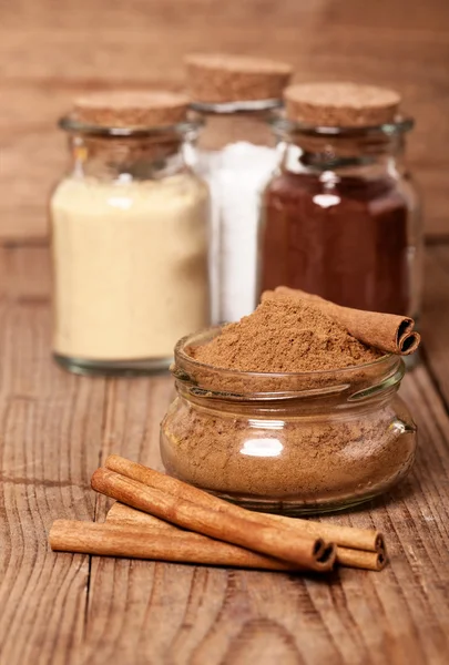 Cinnamon, or chinese cinnamon in the transparent glass jar with — Stock Photo, Image