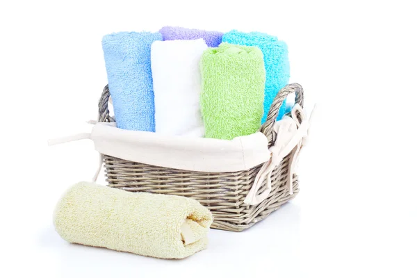 Colorful towels in basket isolated on white — Stock Photo, Image